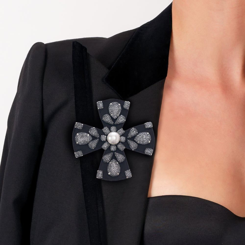 Lace net with pearl cross brooch/pendant on model.