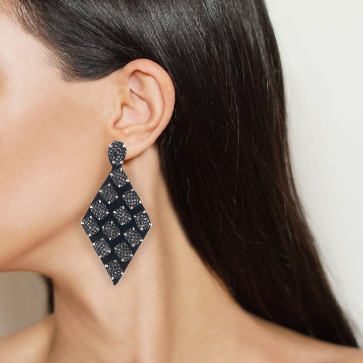 Rhombus lace net earrings on model.