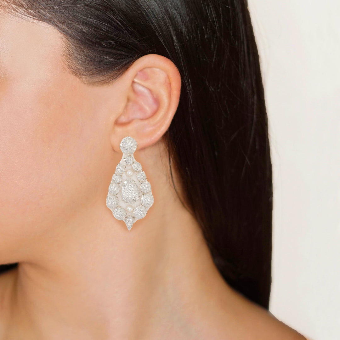 Bell bridal ivory lurex earrings on model.