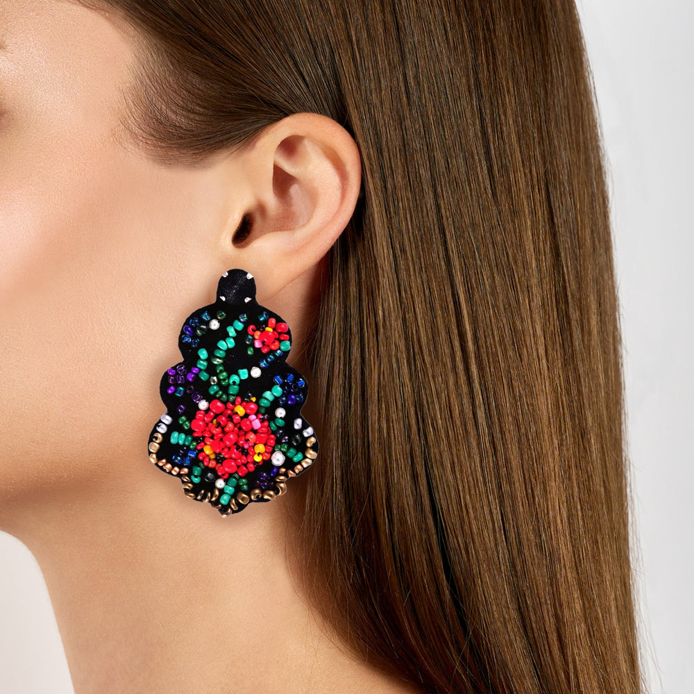 Etno floral motive multicoloured beads chandelier earrings on model.