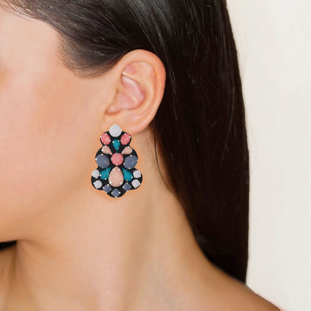Chandelier multicoloured earrings on model.