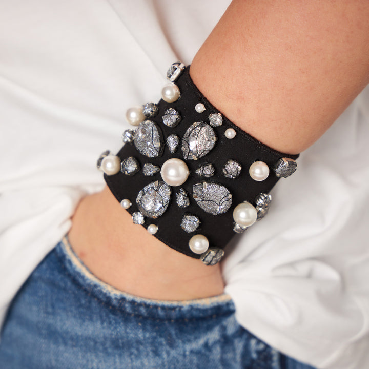 Classic lace cuff with pearls on hand.