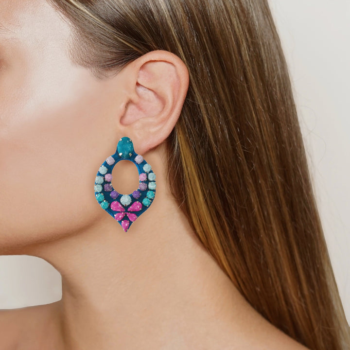 Drop multicoloured earrings on model.