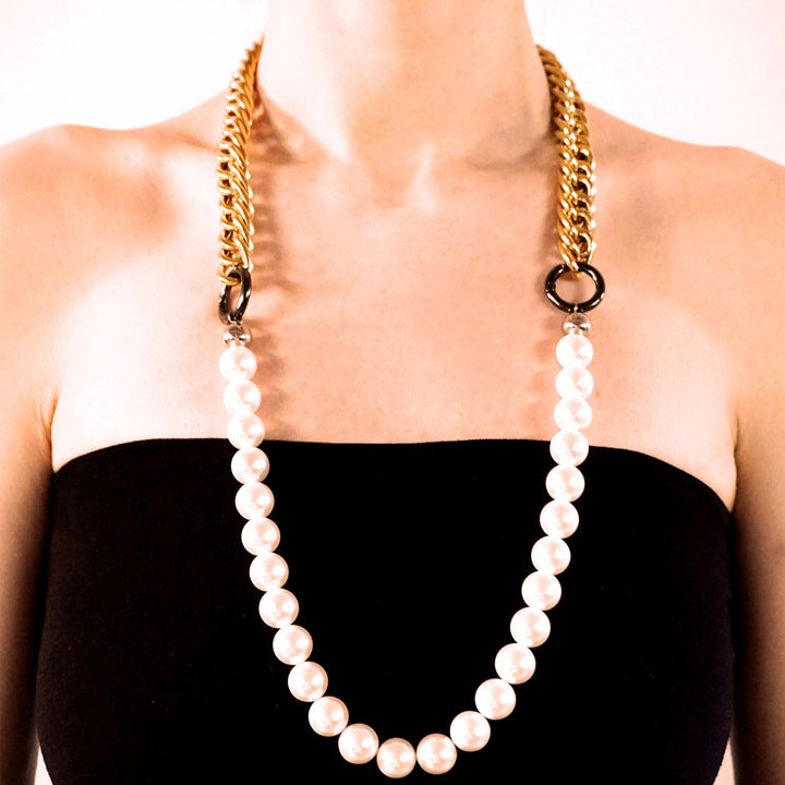 Duo necklace metallic and pearls worn long on model.