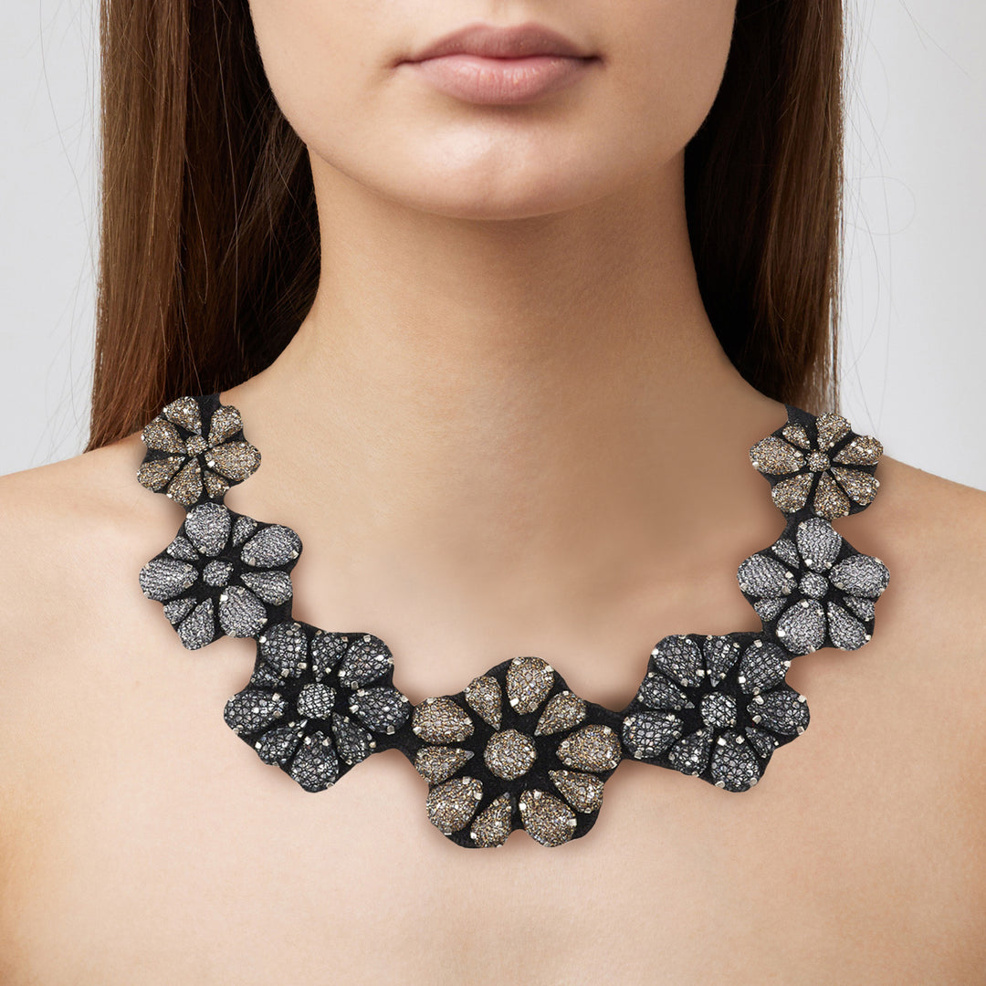 Flower dark silver and gold lace net necklace on model.