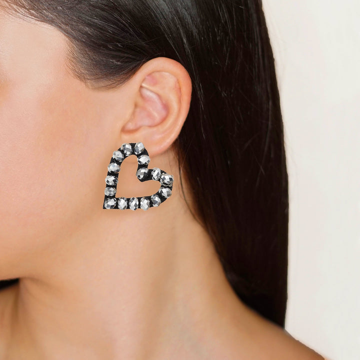 Hearts sparkling beads earrings on model.