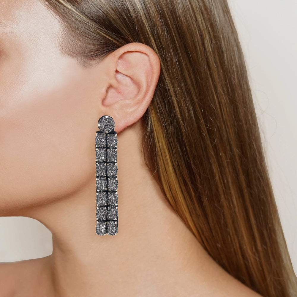 Mosaic lace net earrings on model.