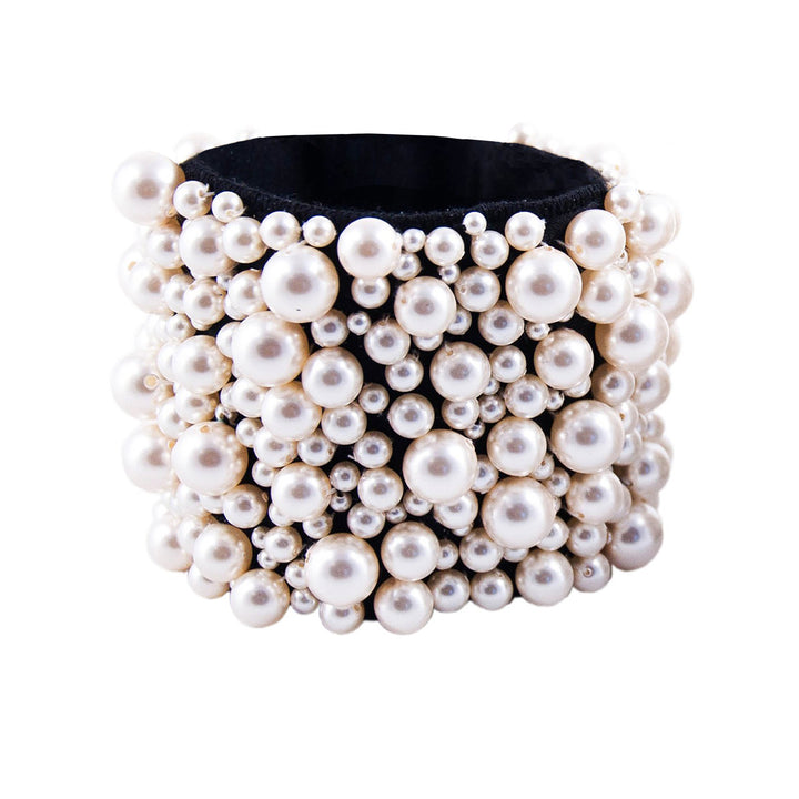 Cuff bracelet covered in pearls.