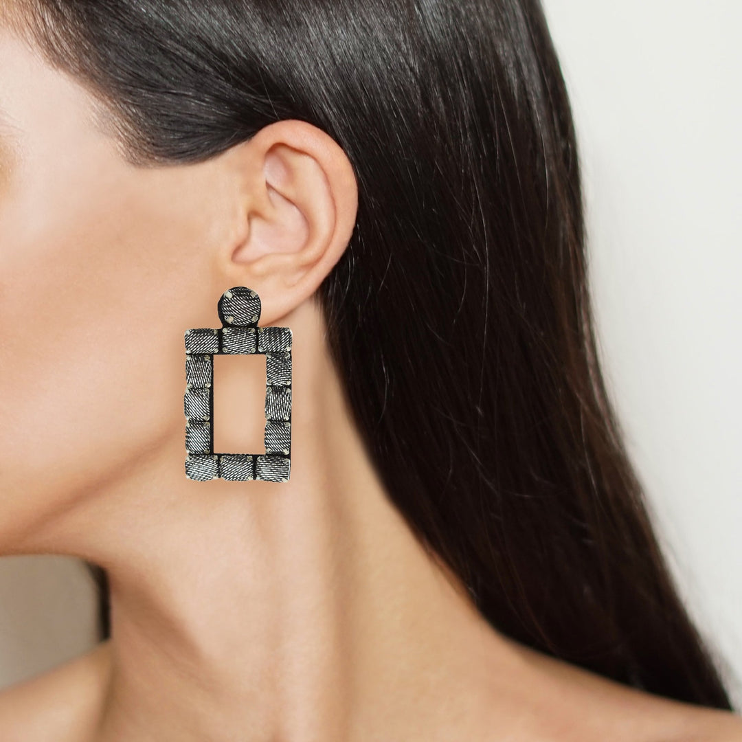 Rectangle lurex earrings on model.