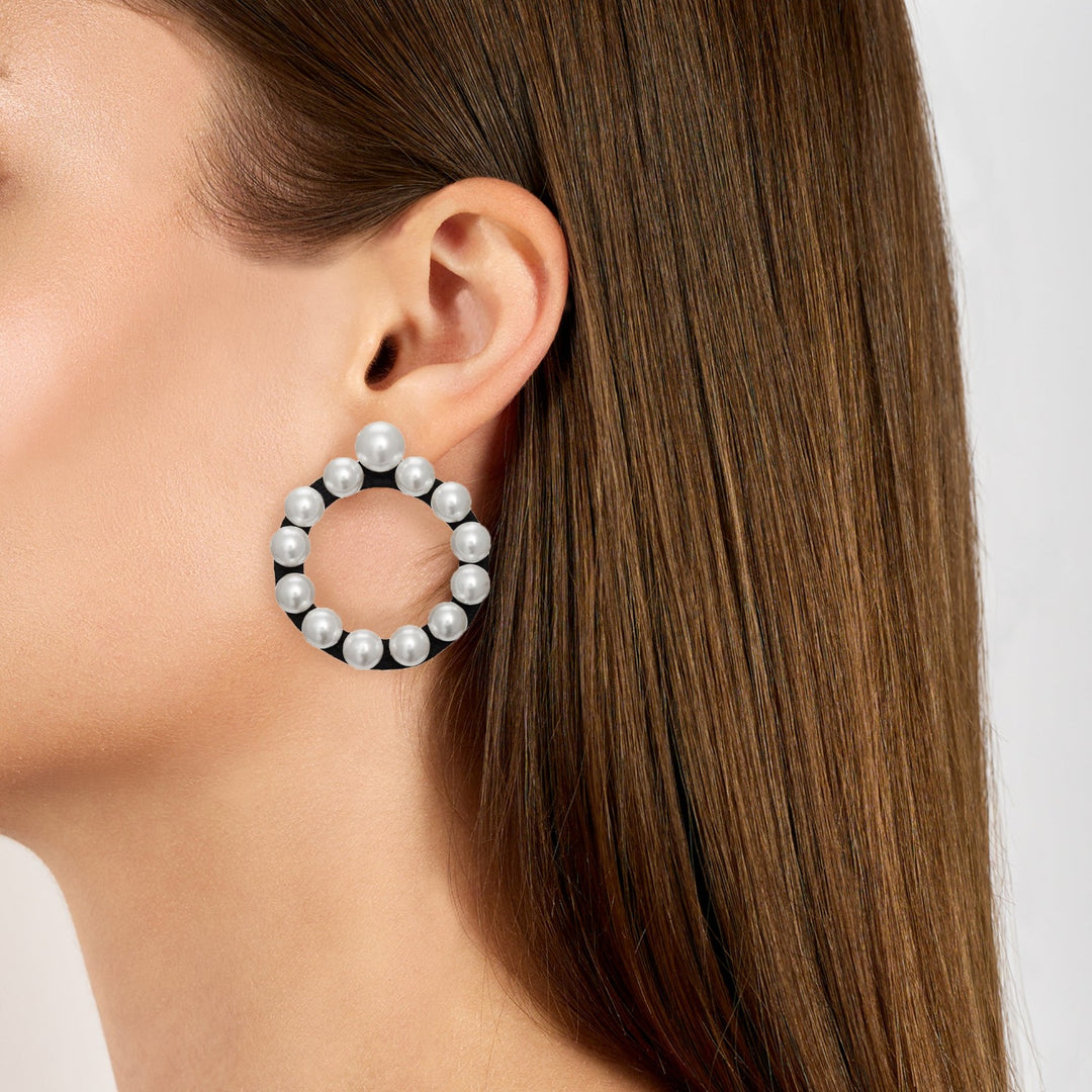 Ring earrings covered in pearls on model.