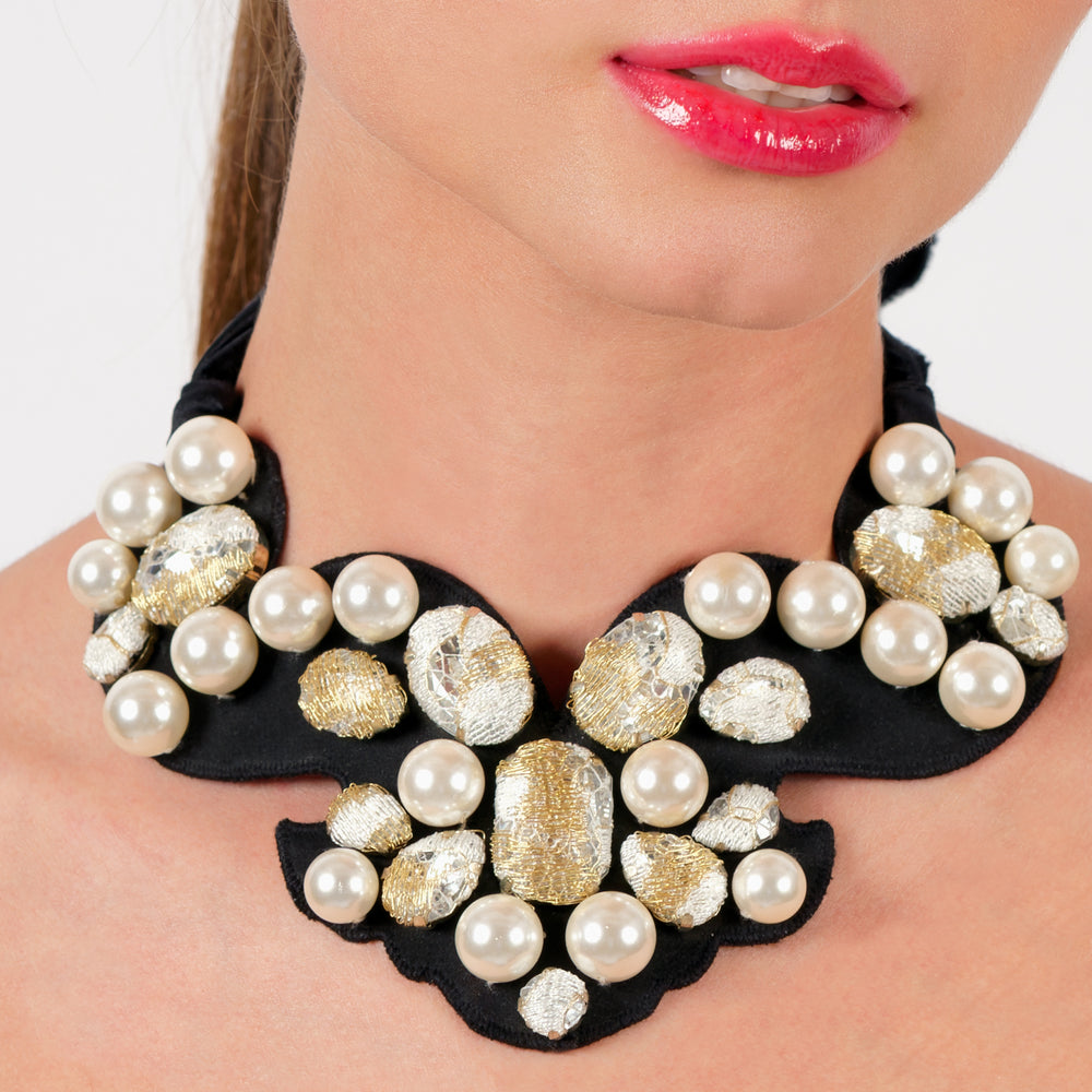 Statement lace necklace with pearls on model.